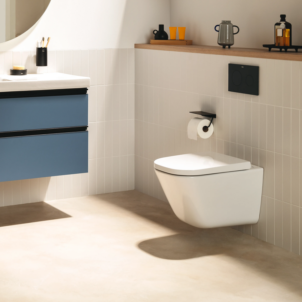 Product lifestyle image of the Roca The Gap Square Wall Hung Compact Toilet mounted on a tiled bathroom wall
